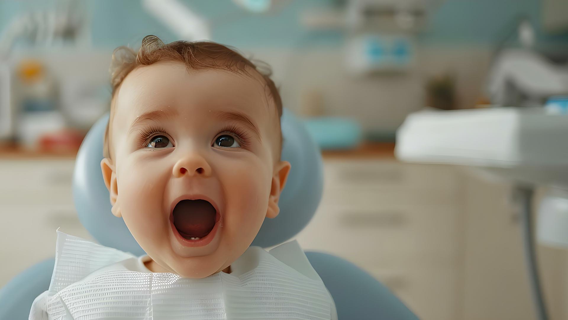 Dental Care for Babies. An adorable baby in a dentist's chair opens wide with a happy expression revealing two new baby teeth.