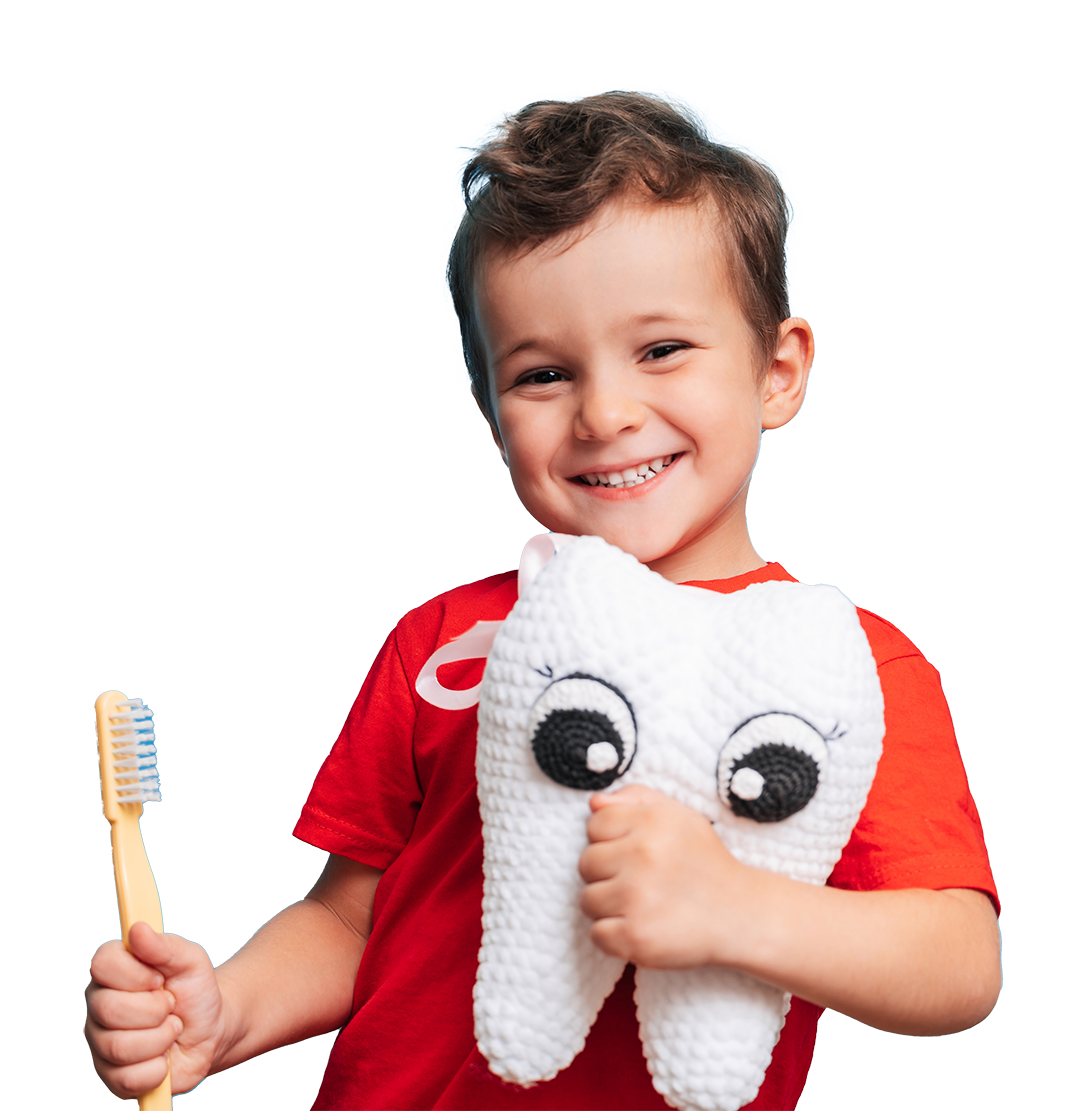 Pediatric Dental Services in Alabaster AL. A smiling child holds a tooth shaped pillow and a toothbrush.