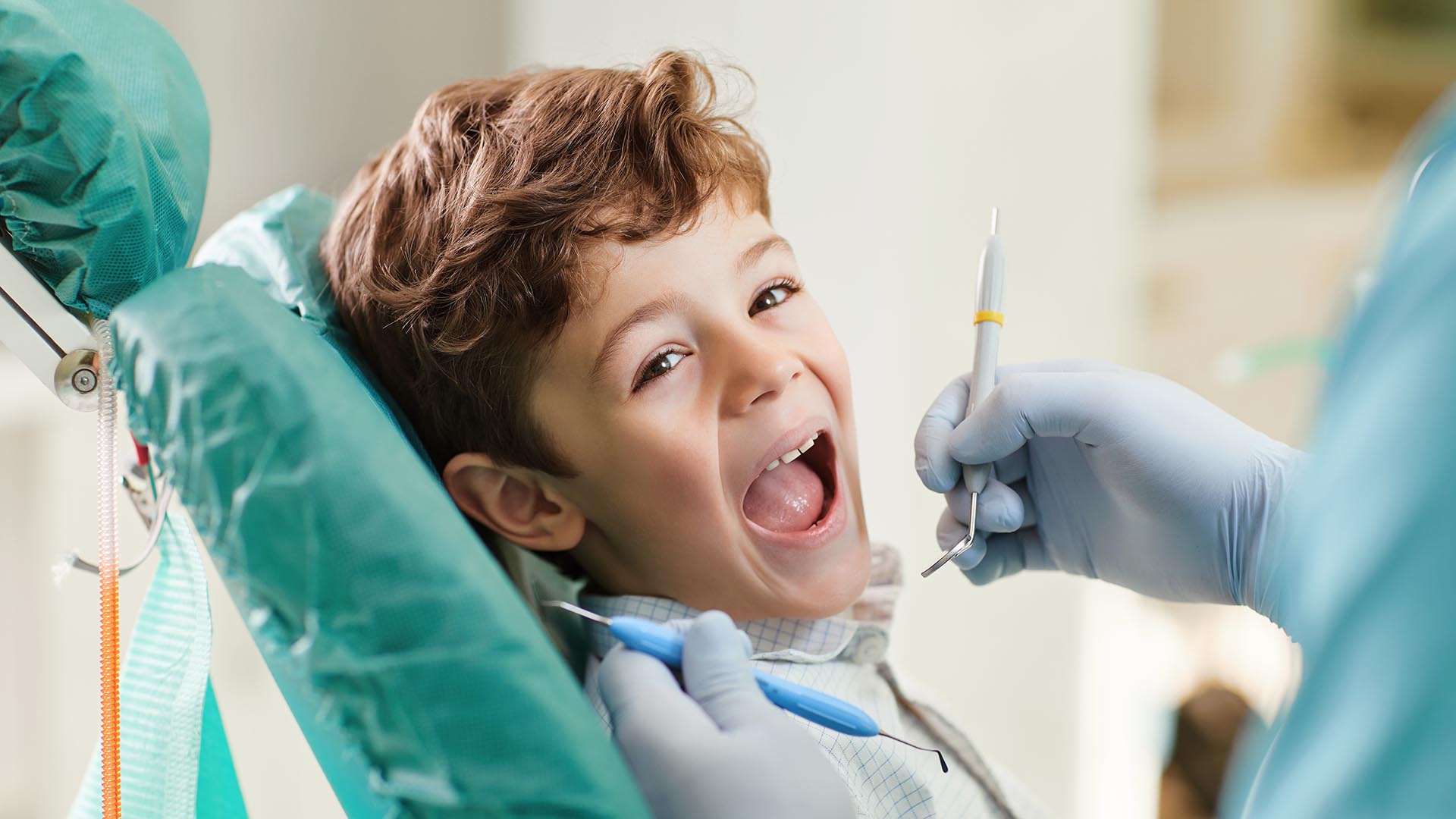 Pediatric Dentistry Birmingham Alabaster Alabama. A smiling child in a dentist's chair happily enjoying their visit.