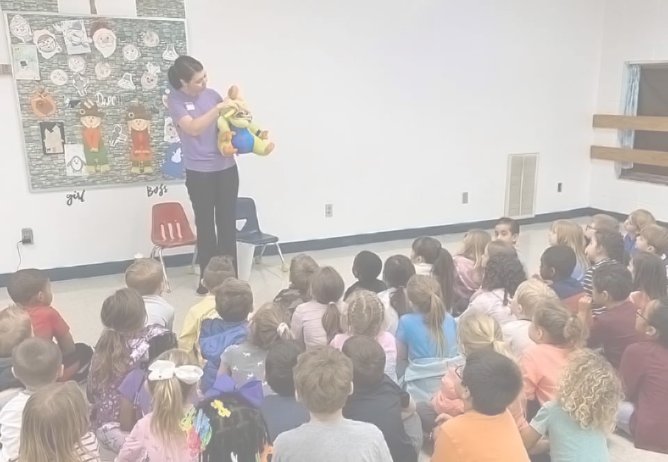 School Education Programs For Elementary. One of the staff members at Alabaster Smiles Pediatric Dental demonstrates how to brush your teeth to the class.